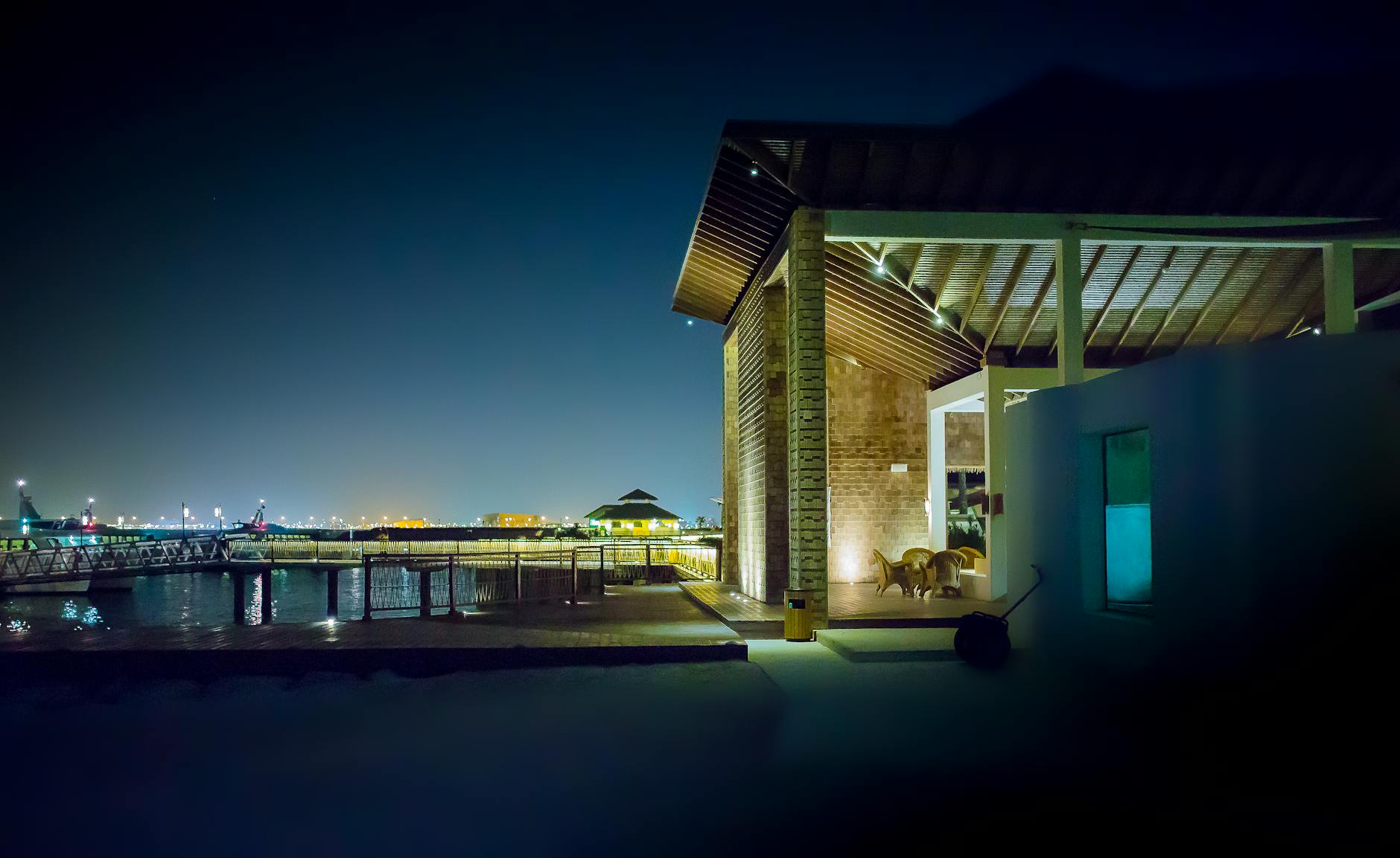 Why have a Smart Home? Picture of warmly lit home on the water.
